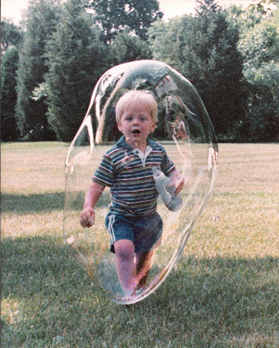 a child playing in a bubble