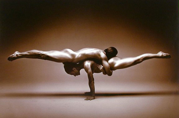 balanced couple posing a yoga move