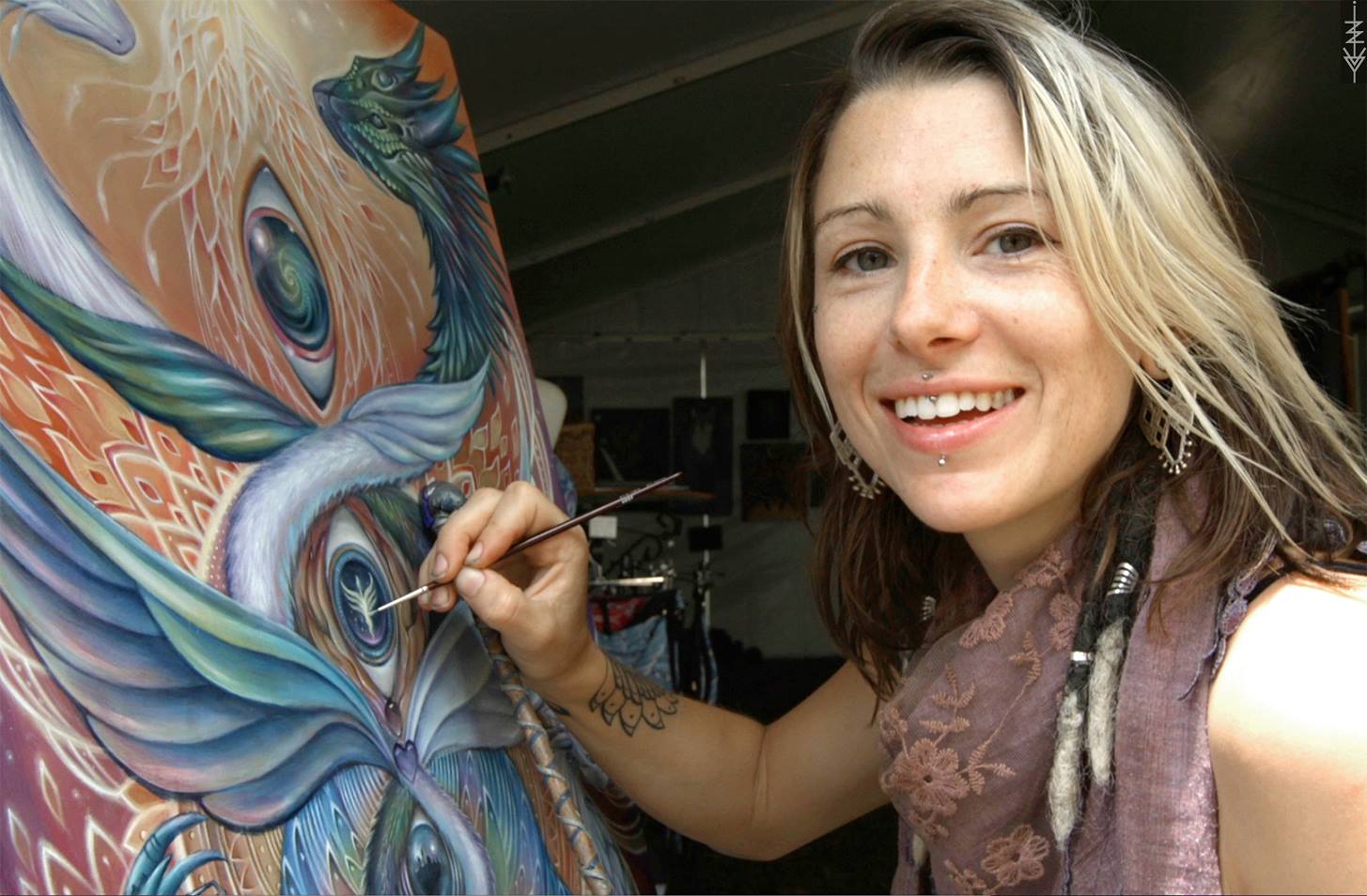 a young lady is painting on a canvass