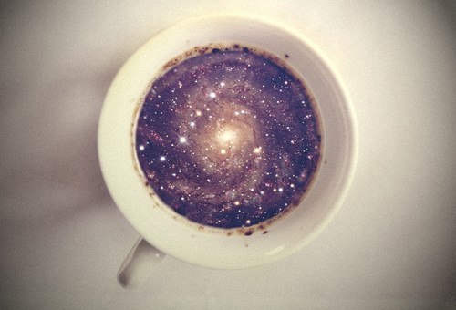 white coffee cup inside coffee with galaxy image