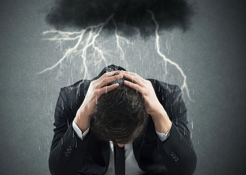 a stressed man under black cloud and thunderstorm